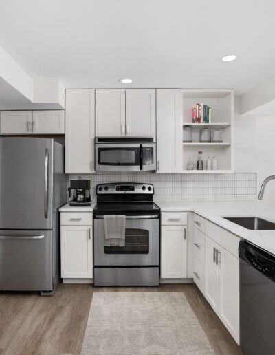 Modern Kitchen With Cabinets, Appliances & Tiled Backsplash